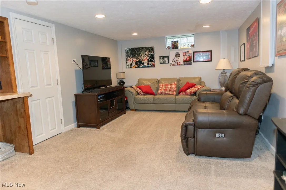 Living room featuring light colored carpet, recessed lighting, and a textured ceiling