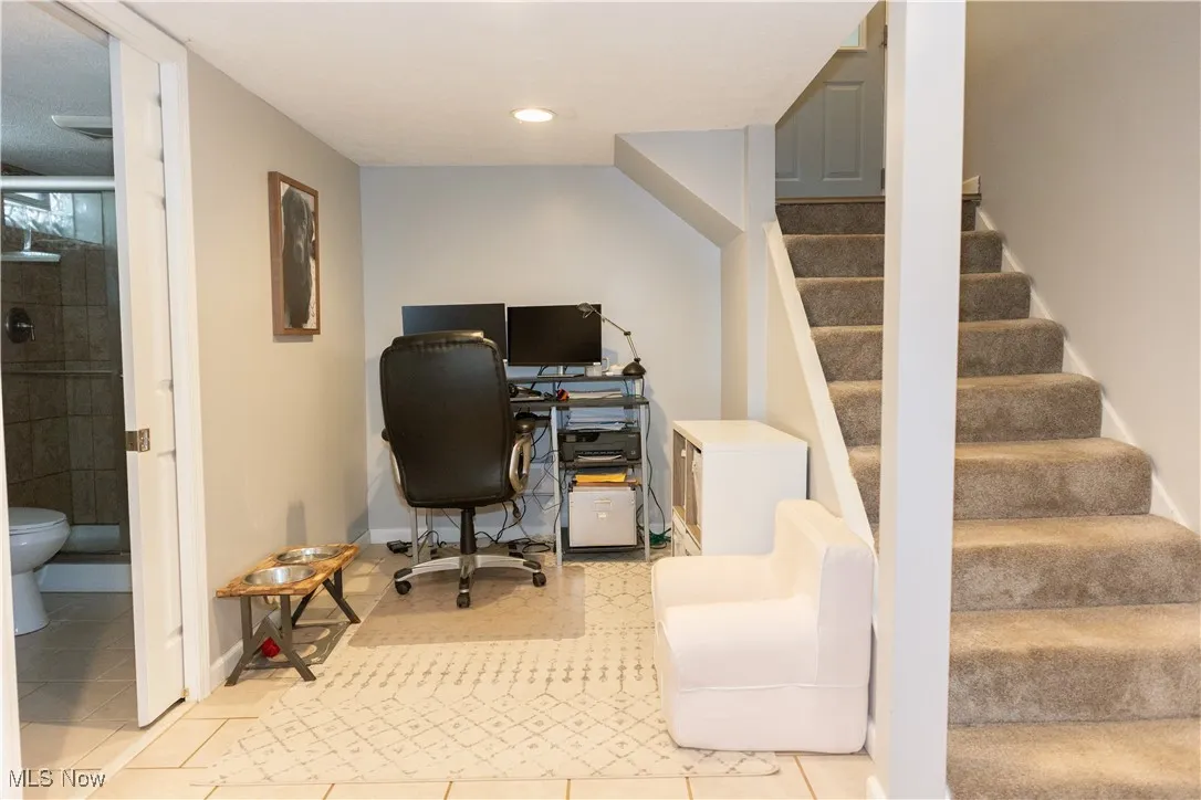 Office space featuring tile patterned floors and recessed lighting