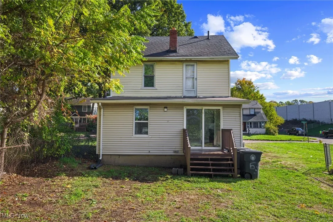Rear view of property featuring a chimney