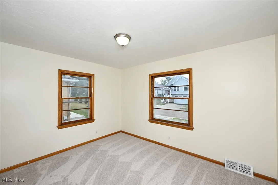 Empty room with carpet flooring