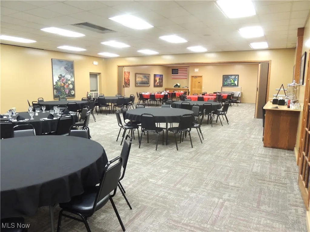 Banquet Room with light colored carpet and a drop ceiling