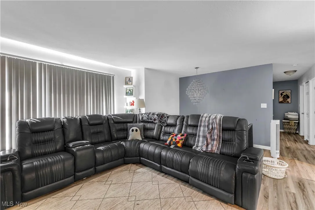 Living area with a chandelier and light wood finished floors