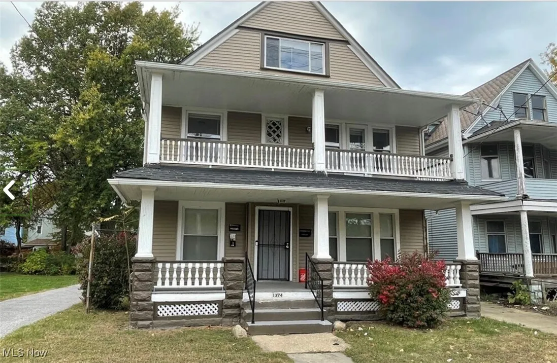 View of front of home featuring covered porch and a front lawn