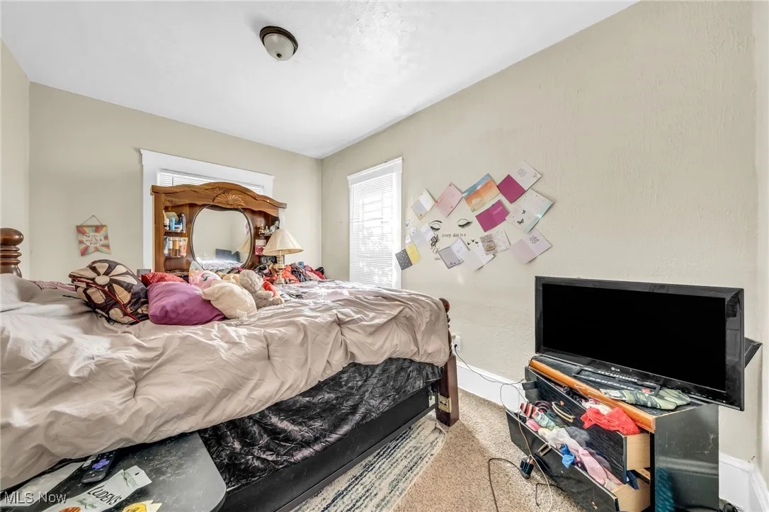 Bedroom with carpet floors and baseboards
