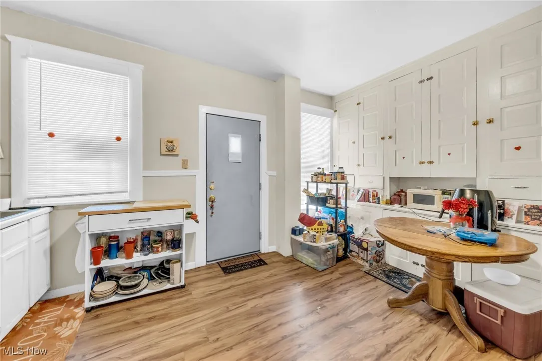 Kitchen featuring white cabinets and light wood-style floors