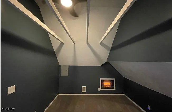 Additional living space with baseboards and lofted ceiling