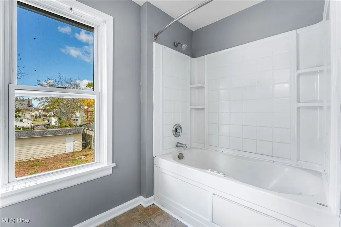 Bathroom with  shower combination and baseboards