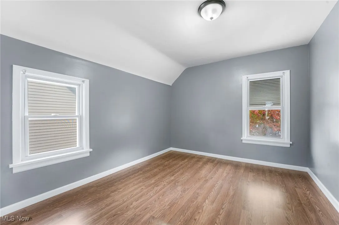 Bonus room with lofted ceiling and wood finished floors