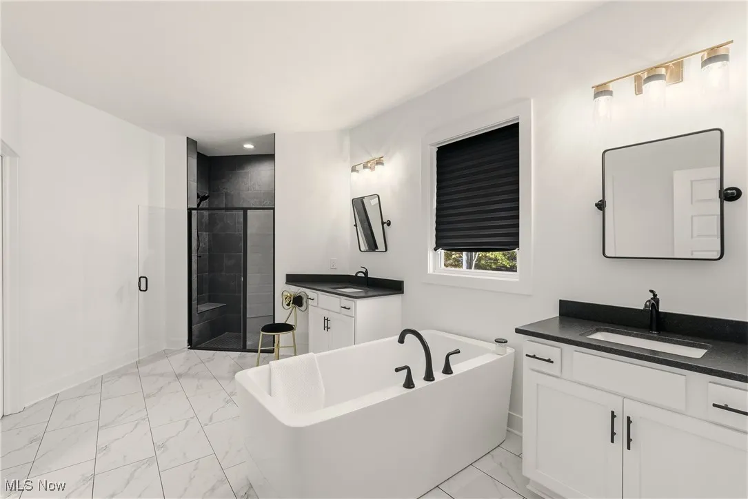 Tile floor, soaking tub, split vanity, tile walk-in shower