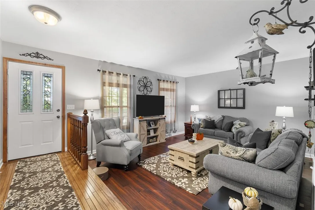 Living area featuring hardwood / wood-style flooring and baseboards