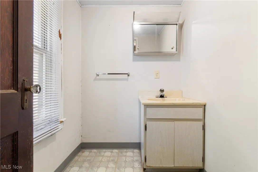 Half bath featuring vanity and light floors
