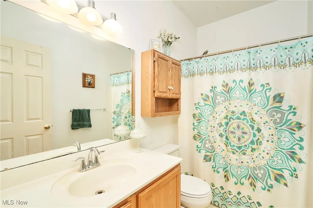 Full bathroom with a shower with curtain and vanity