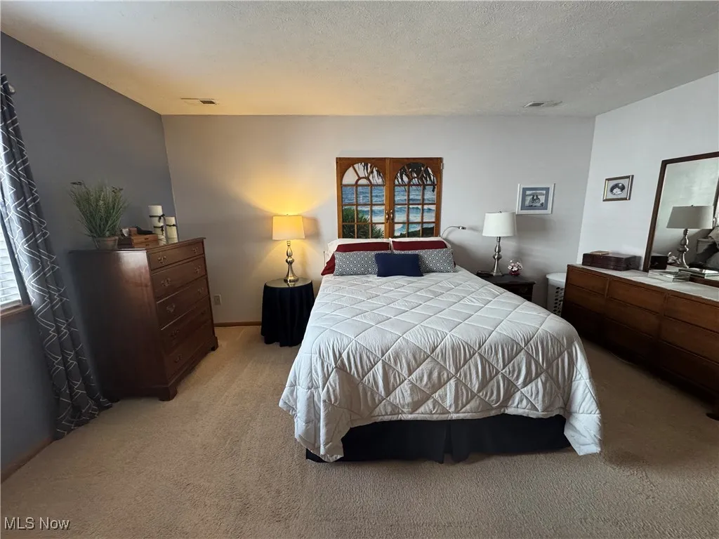Bedroom with carpet floors and a textured ceiling