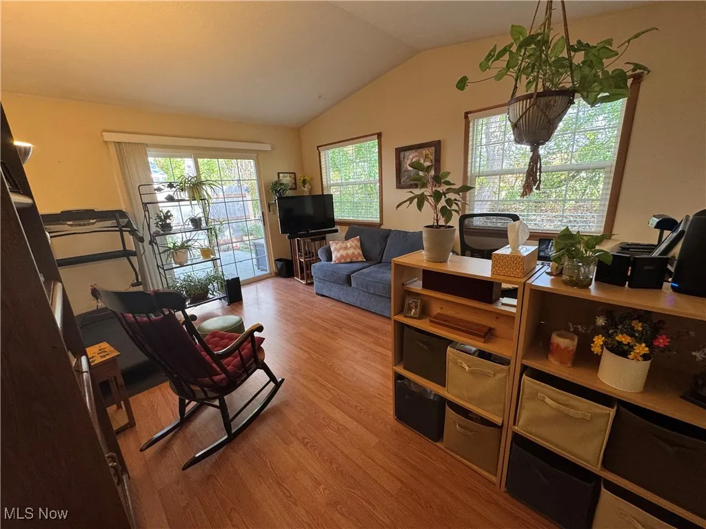 Living room with vaulted ceiling, healthy amount of natural light and slide to patio