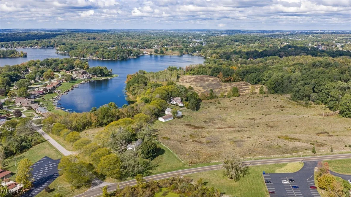 Bird's eye view of a heavily wooded area and a nearby body of water