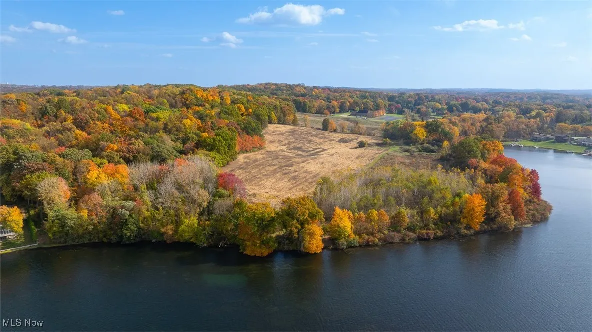 Bird's eye view of a nearby body of water and a heavily wooded area