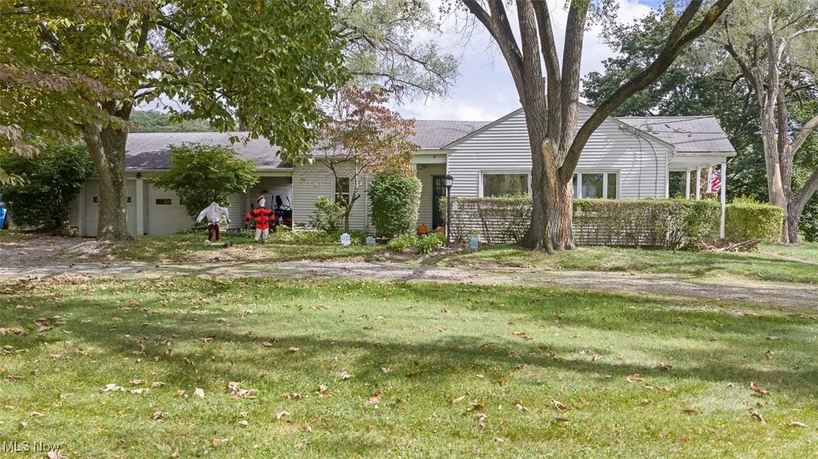 Ranch-style home with a front yard and an attached garage