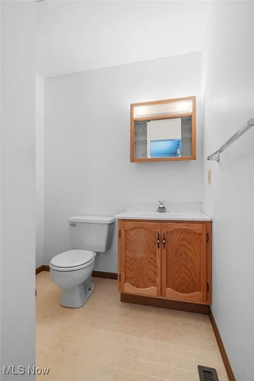 Bathroom with vanity and light floors