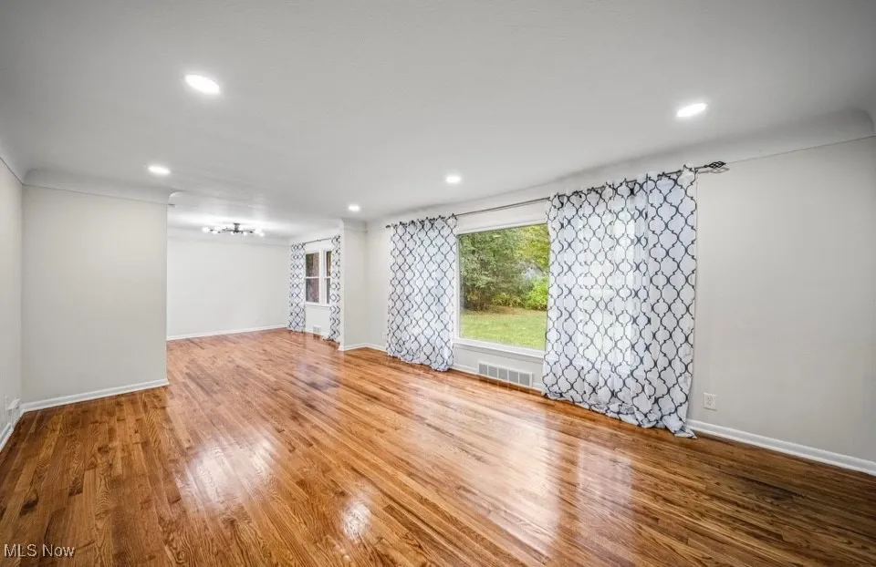 Living Room with wood finished floors and recessed lighting