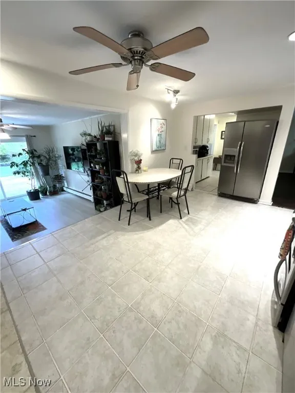 Dining area featuring ceiling fan and light tile patterned floors