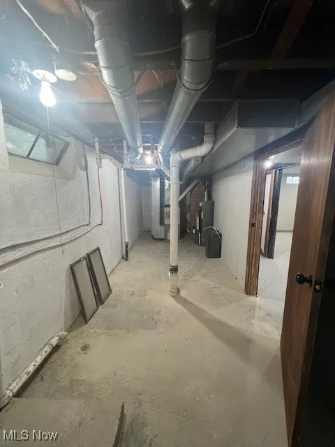 Unfinished basement with water heater and heating unit