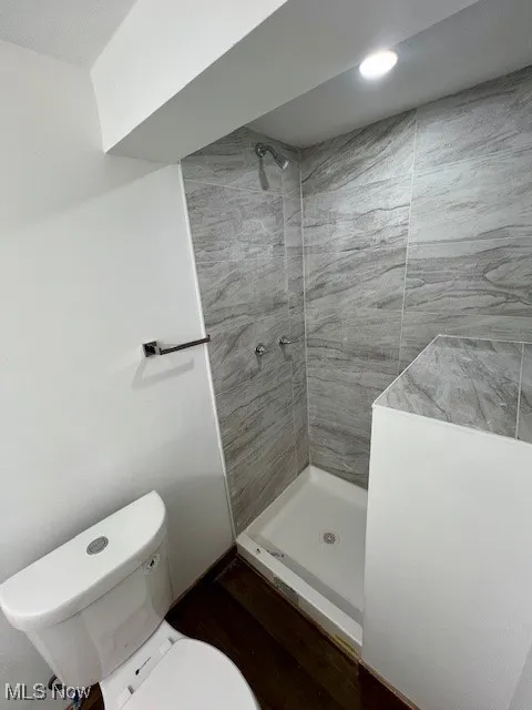 Bathroom featuring a stall shower and wood finished floors