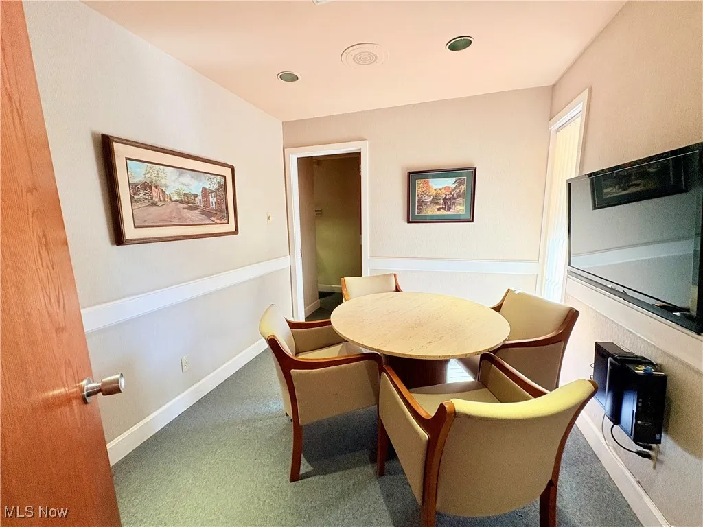 Carpeted consultation room with baseboards