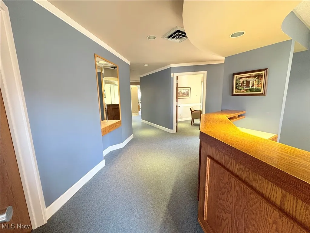 Corridor featuring carpet, ornamental molding, and recessed lighting