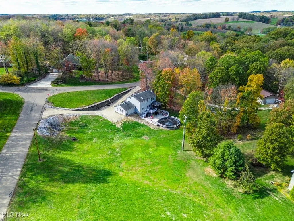View of property location with a heavily wooded area
