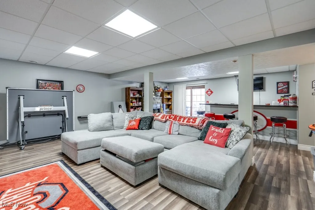 Living area featuring a paneled ceiling and wood finished floors