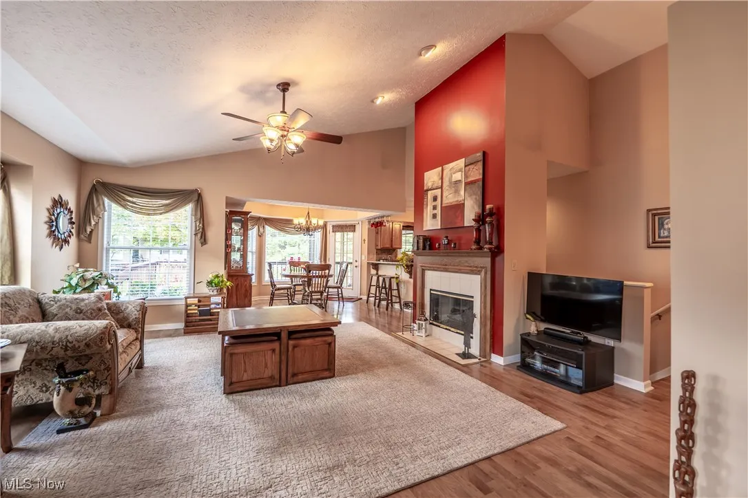 Vaulted Great room is spacious with ceiling fan and gas FP