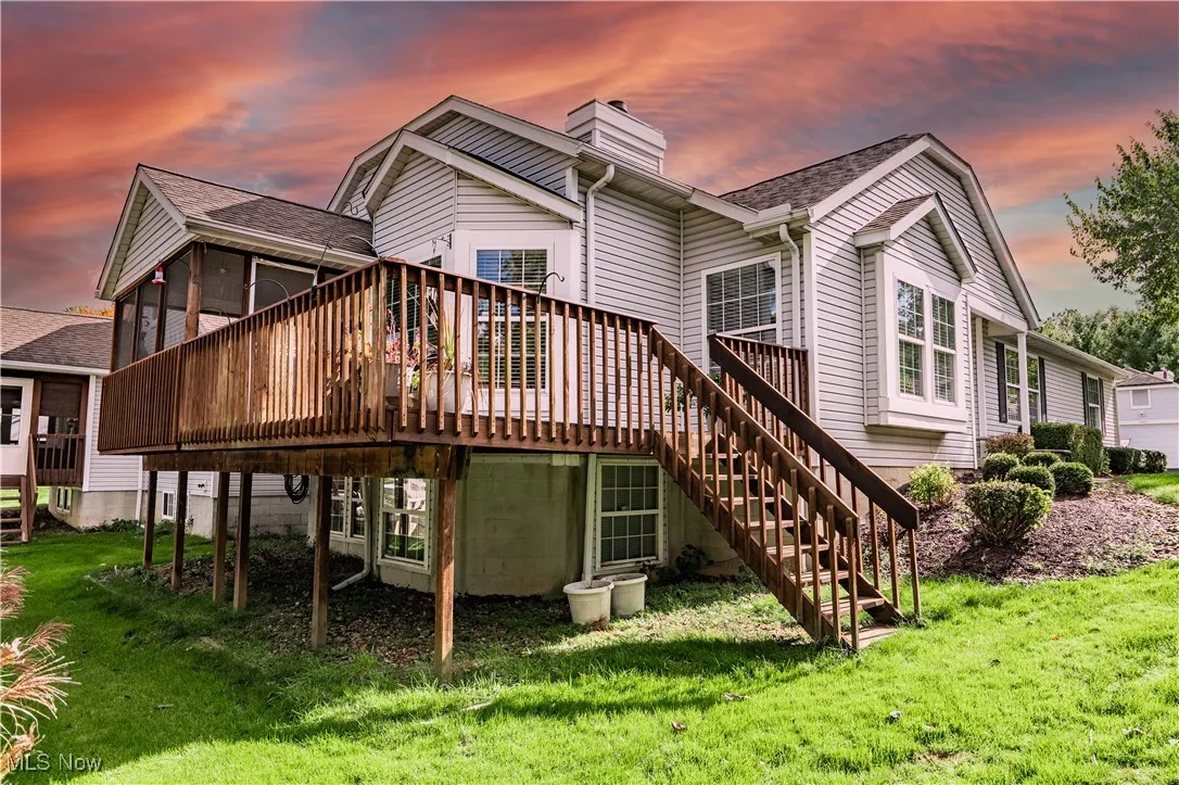 Deck off the screened porch leads to side yard