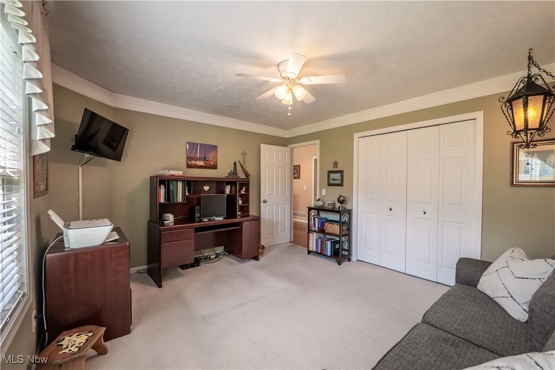 Large 2nd bedroom with overhead ceiling fan currently used as an office. Hanging light fixture does not stay.