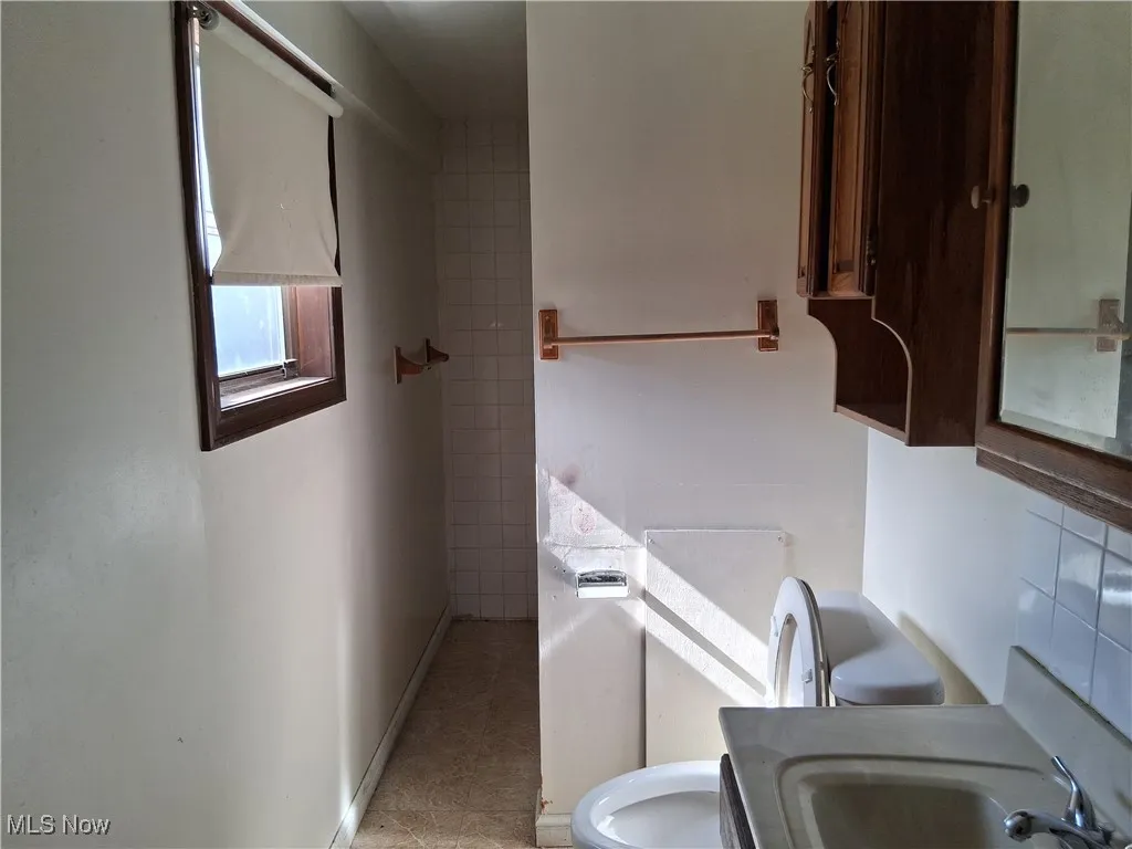 Bathroom with a sink and baseboards