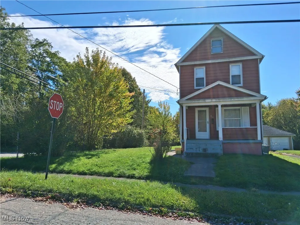 View of front facade featuring a porch and a front lawn