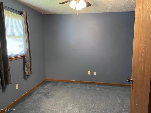 Jack and Jill bedroom with a textured ceiling, and a ceiling fan and carpet.