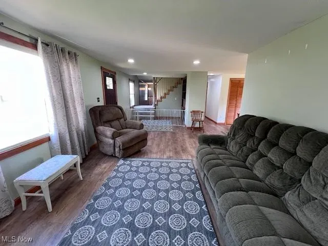 Living area with laminate floors, picture window and recessed lighting