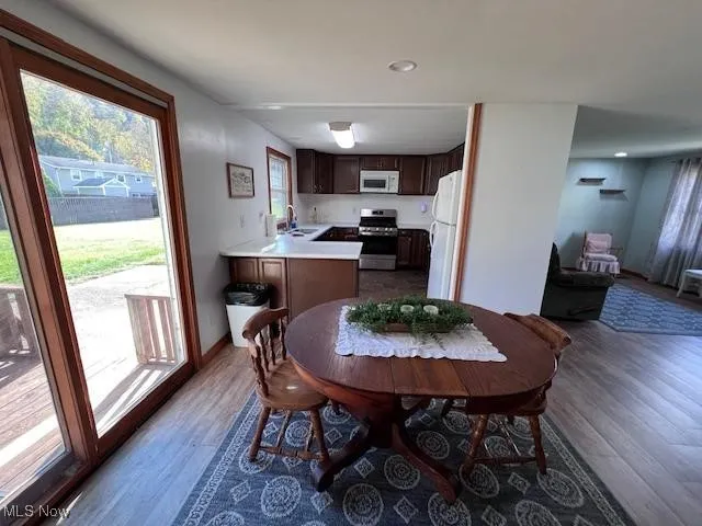Dining area featuring laminate flooring and recessed lighting. Pella sliding doors to back deck area and yard access.