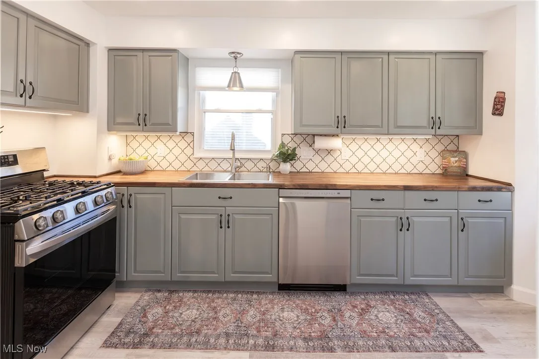 Stunning refinished cabinetry with butcher block countertops!