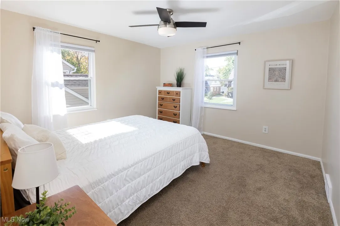 Bedroom #2 offers updated windows, plush carpet with hardwood underneath and a closet!