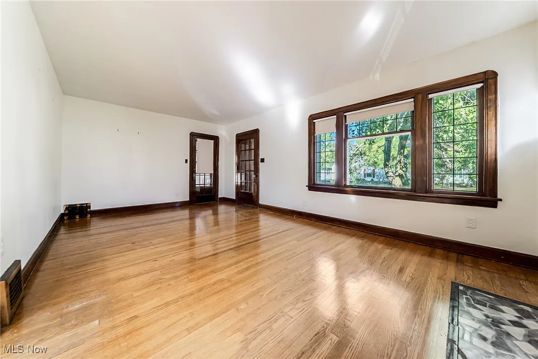 Spare room featuring baseboards and light wood-style floors