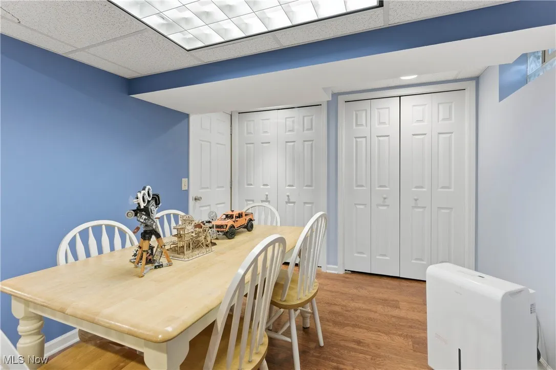 Dining room featuring wood finished floors and a drop ceiling