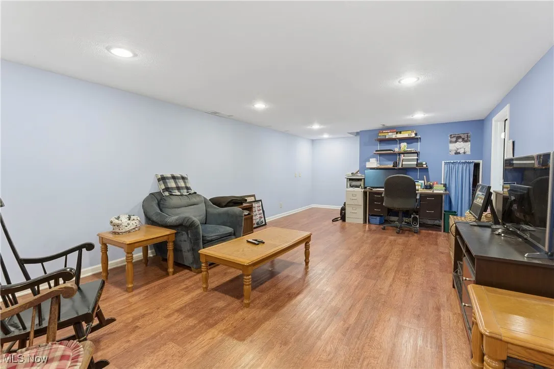 Office space with light wood finished floors and recessed lighting