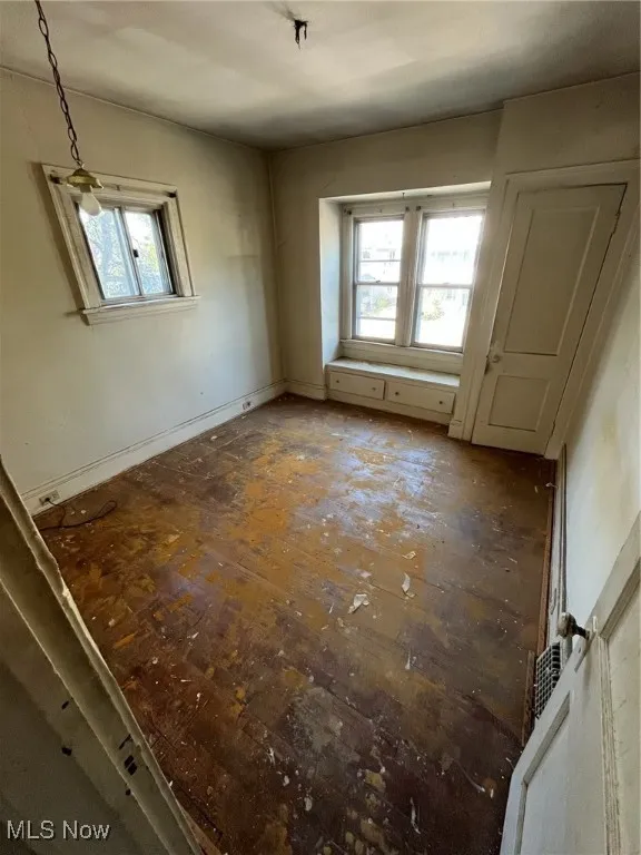 Unfurnished room featuring baseboards