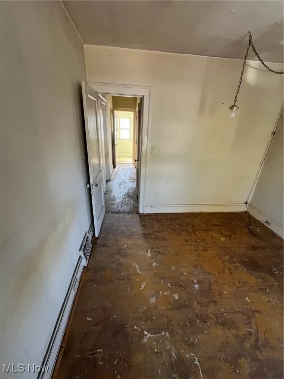 Unfurnished room with baseboards