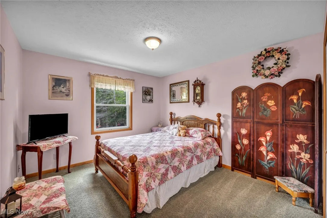 Bedroom featuring a textured ceiling and carpet flooring