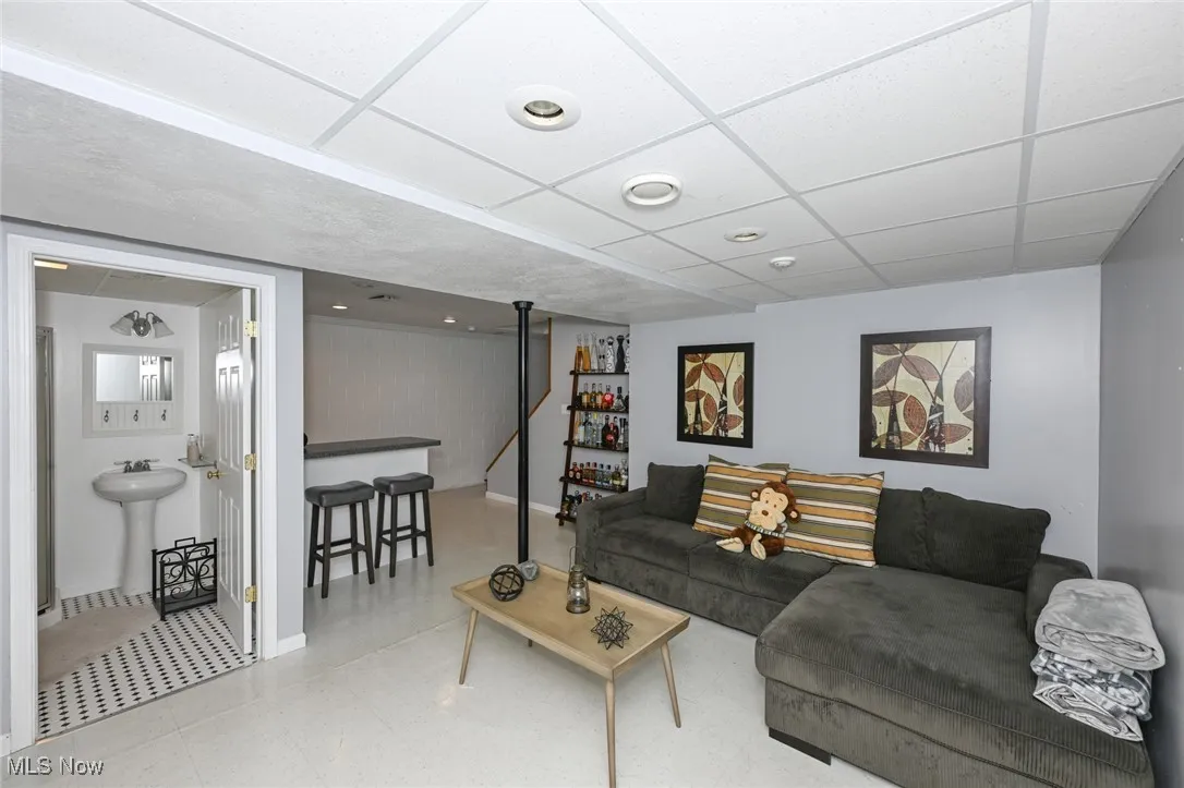 Basement - Living area with a drop ceiling and tile patterned floors