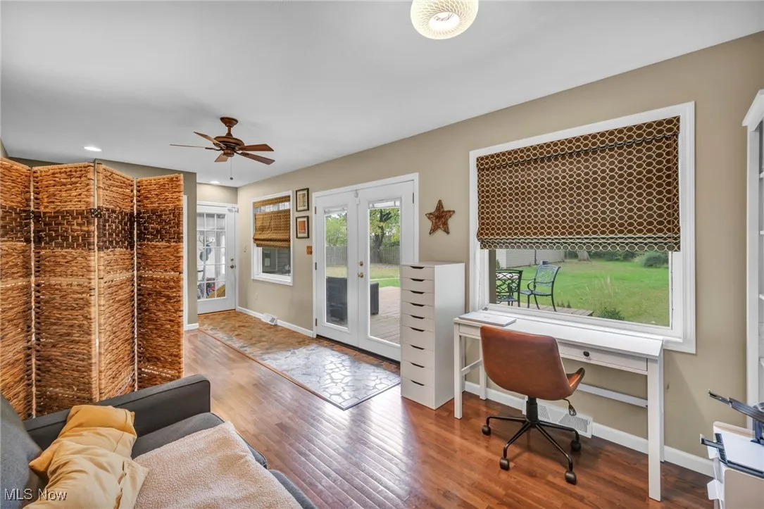 Office with hardwood / wood-style floors, and a ceiling fan