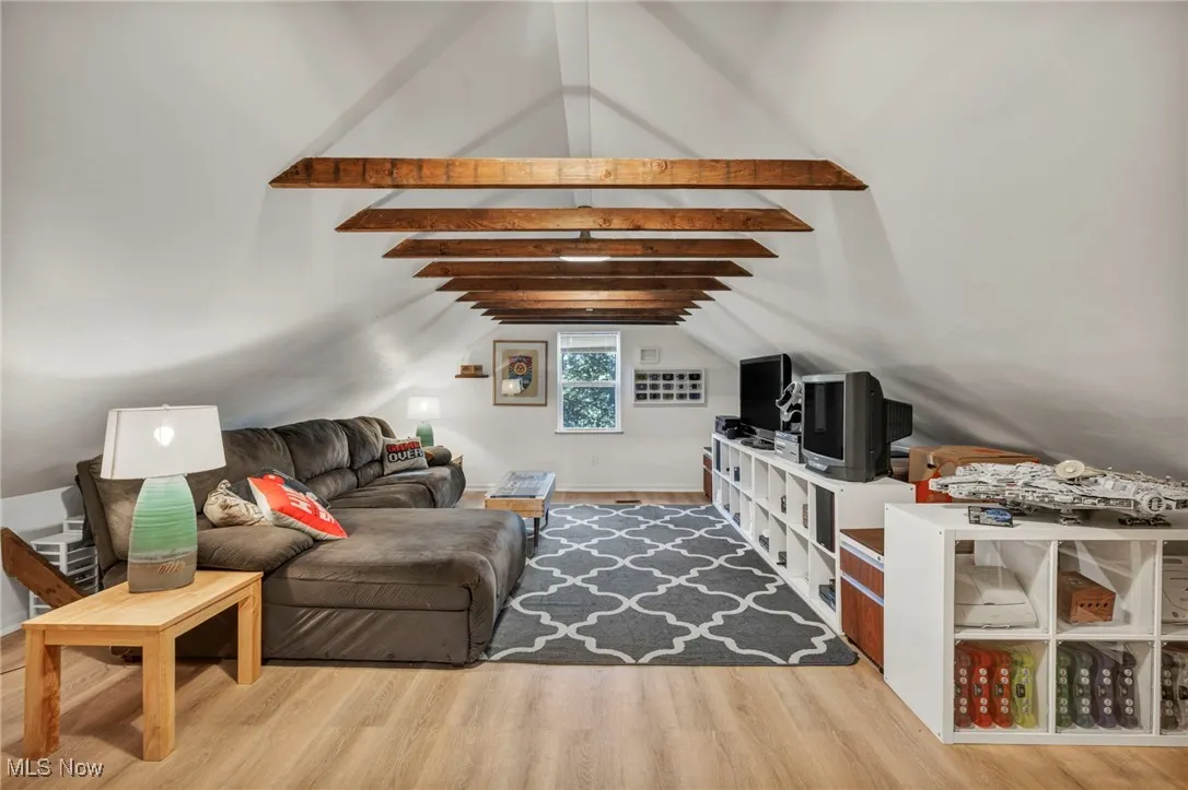 Living area with wood laminate flooring in the loft of garage