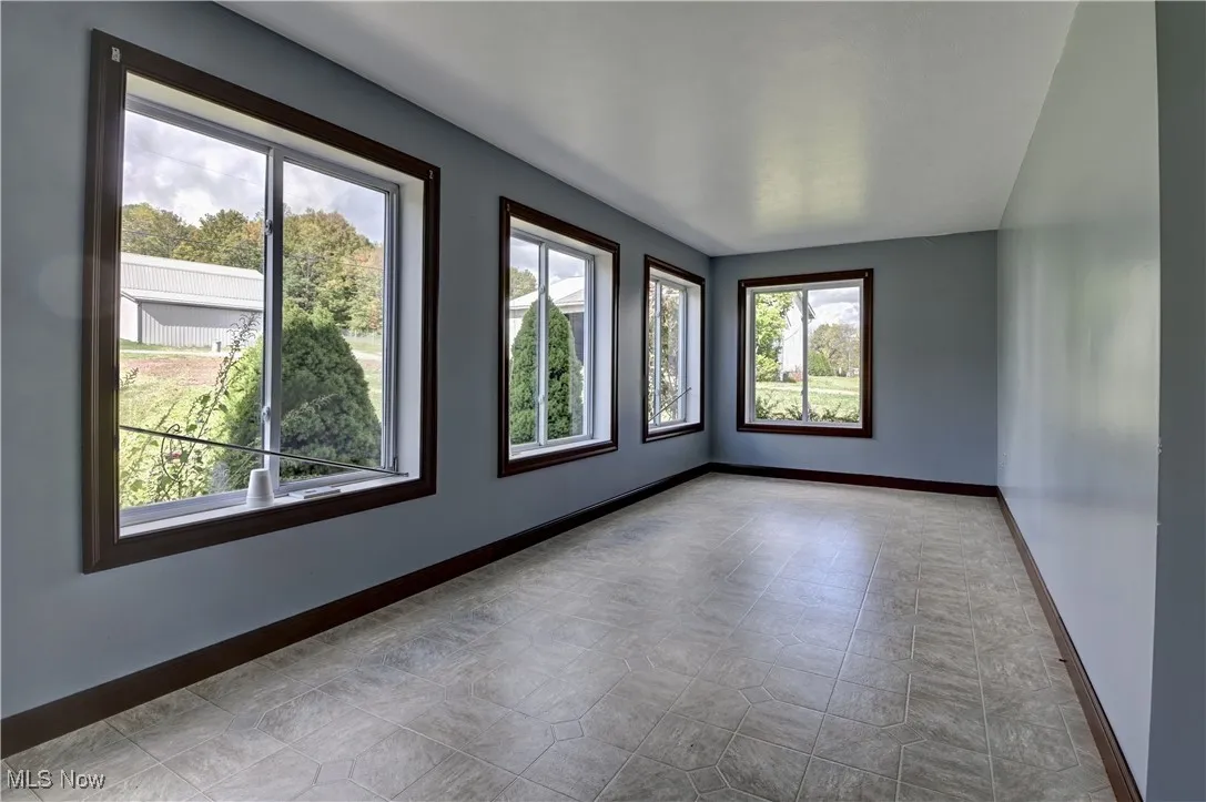 Spare room featuring baseboards